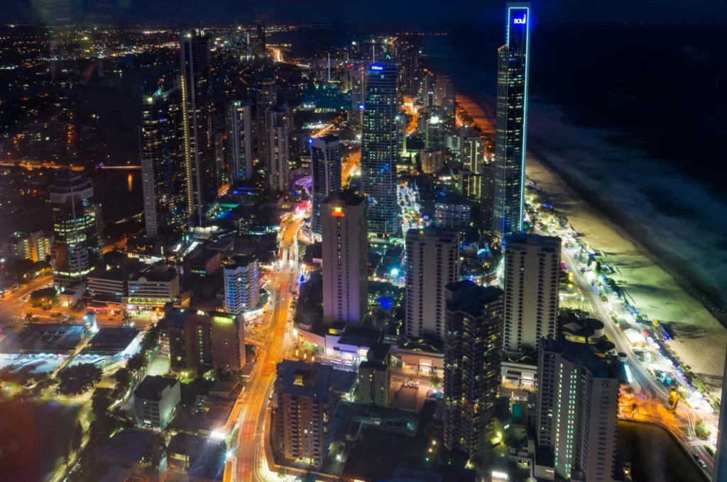 Aerial night view of the Gold Coast skyline lit up along the beachfront